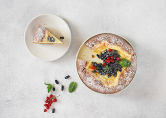 Homemade german cheesecake kasekuchen with berries on plate on table. Top view