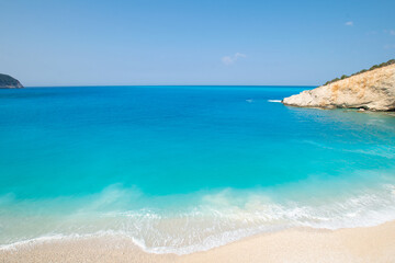 Fototapeta na wymiar Turquoise sea and waves at Lefkada island during summer in Greece