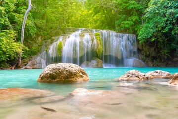 Erawan Waterfall beautiful rainforest with sunlight in Thailand