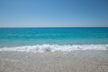 Fototapeta na wymiar Turquoise sea and waves at Lefkada island during summer in Greece