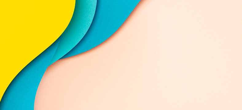 Abstract color papers geometry flat lay composition with shaped blue, yellow color lines on pastel background. Top view, copy space