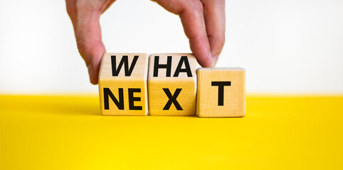 What next symbol. Concept words What next on wooden blocks. Businessman hand changes words what to...