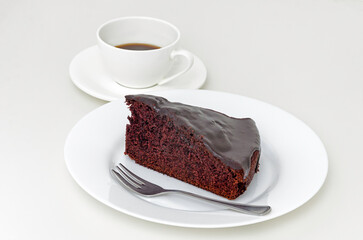 Piece of chocolate cake with cup of coffee