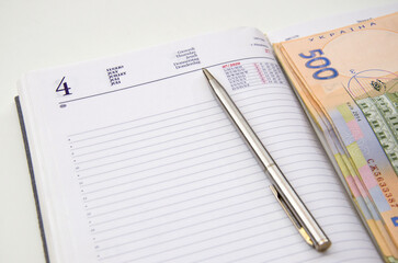 Notebook, money and pen