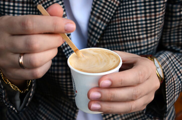 Fototapeta na wymiar Person holding a cup of coffee