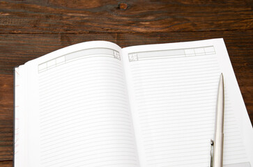 Paper note and pen on a wooden desk