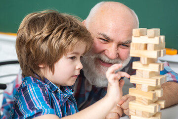 Close up portrait of grandfather and grandson child playing at home.