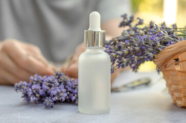 Fototapeta na wymiar White frosted lavender oil bottle and fresh lavender flowers
