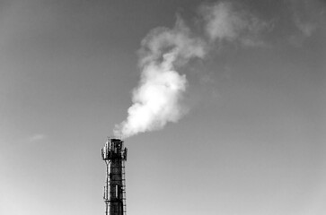 Smoke emission from pipe against a sky
