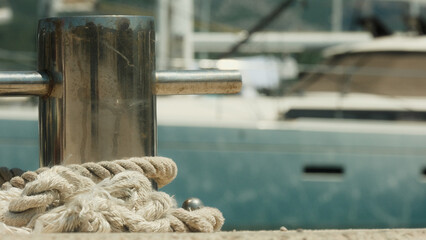 Metallic knecht on the pier with rope