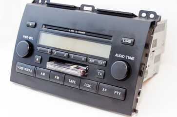 Old car audio CD and cassette player 2 DIN. On a lite background