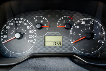 A car instrument panel with speedometer, tachometer, odometer