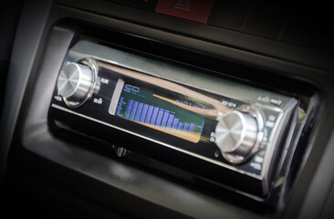 Old hi-fi car audio CD player in car`s dashboard. Closeup view