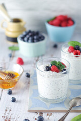 Greek yogurt in glasses with berries and quinoa