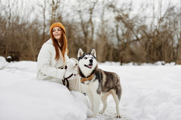 young woman winter outdoors with a dog fun nature Lifestyle