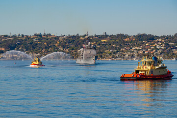 A warship returning from deployment into San Diego Harbor, California.
