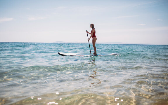 Photo of woman paddling SUP board