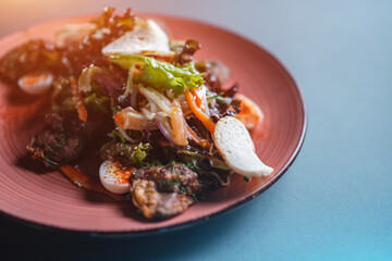 closeup of warm salad with chicken liver, egg and crouton on black background