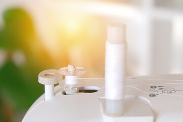 Winding threads on a bobbin on a sewing machine.