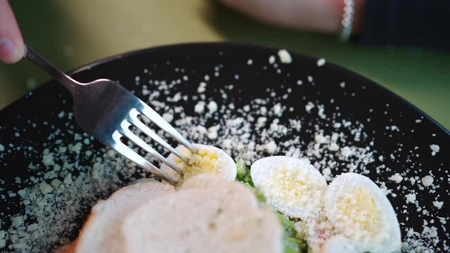 person eating resh caesar salad with lettuce, grilled chicken crusty bread toast