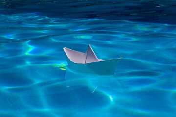 Cruise liner paper art. Paper boat sailing away on sea surface water background. Origami toy ship ,...