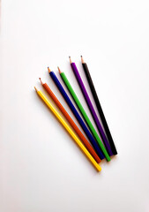 Back to school concept. Composition with multicolored pencils on white background. Hobby mock up. Flat lay, top view. Blank space. Summer color palettes.