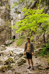 Tourists go along the mountain route. Rocks and forest