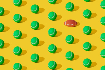 Arranged of green rubber tennis balls and one rugby ball on yellow pastel background. Pattern.