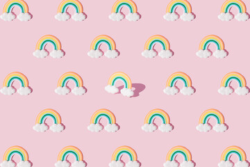 Small colorful rainbow with clouds. Pattern.