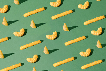 Various snacks on a green background. Pattern.
