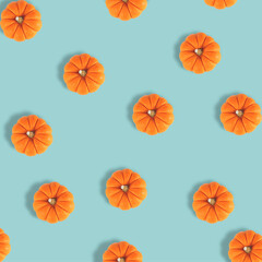 Many pumpkins on pastel blue background. Fall autumn halloween concept. Flat lay, top view. Autumn pattern.