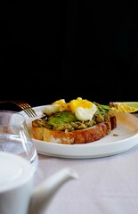 Avocado toast with poached egg. Cutting process.