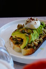 Avocado toast with poached egg. Cutting process.