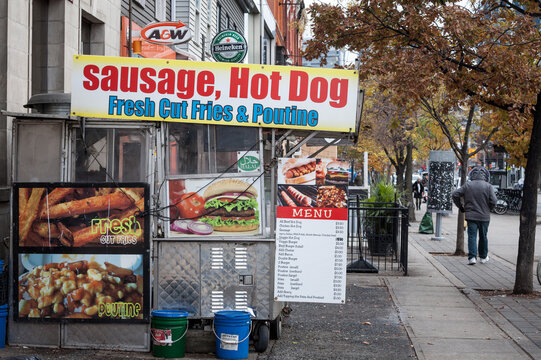 TORONTO, CANADA - NOVEMBER 13, 2018: Traditional North American hot dog stand in Downtown Toronto, Ontario, selling sausages, fries and poutine in a street near CBD.
