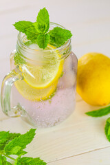 Lemon mint water .Citrus cocktail with mint leaves. Sassy lemon water.Lemon summer drink.Dietary lemon drink.Sprig of mint in a glass with a cocktail.