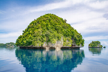 Fototapeta na wymiar Calm Ocean and mushroom shape islands, sky reflection, UNESCO World Heritage Site, Rock Island Southern Lagoon, Koror state, Palau