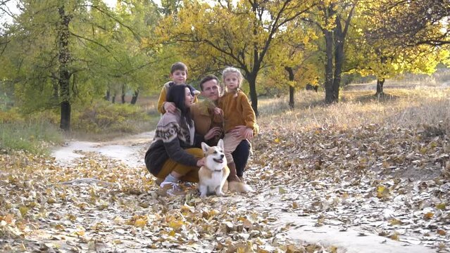 Happy young family spending time outdoor with their dog