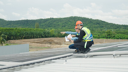 Two engineers inspecting solar cell powder on factory roof