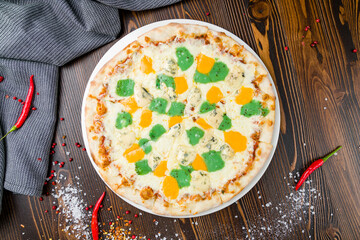 Pizza Quattro formaggi on a wooden table