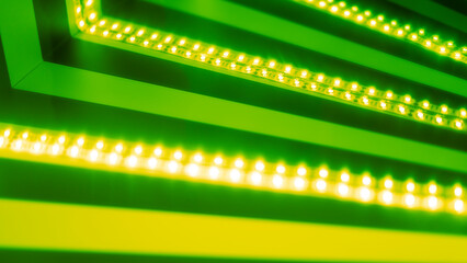 Obraz premium glowing LED stripes in green for background use 