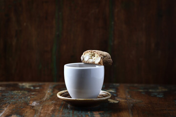 Cantuccini (Italian cookie) and a Cup of coffee on dark wooden background. Copy space