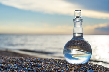 Glass flask by the sea.
