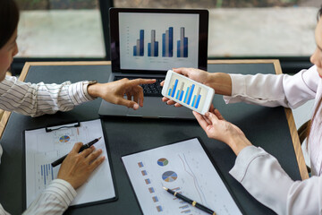 Coworker business concept, Businesswoman pointing chart financial to discussing project together