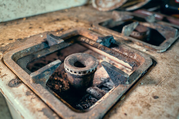 Dirty rusty gas burner of an old gas stove