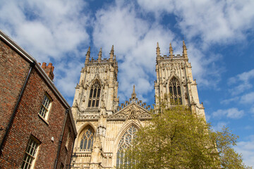Fototapeta na wymiar Cityscape exterior front view of the gothic style Cathedral and Metropolitical Church of Saint Peter, commonly known as York Minster, in the city of York, England