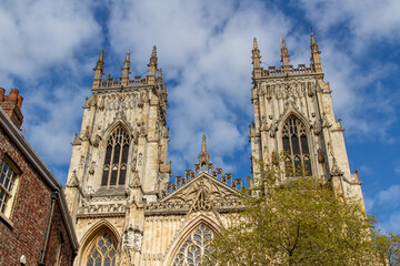Fototapeta na wymiar Cityscape exterior front view of the gothic style Cathedral and Metropolitical Church of Saint Peter, commonly known as York Minster, in the city of York, England