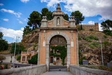 Fototapeta na wymiar Old Stone entrance gate in The Old town of Toledo, Spain