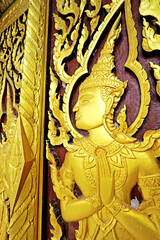 Decorative of wood carving on the door in Thai temple