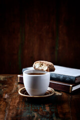 Cantuccini (Italian cookie) and a Cup of coffee on dark wooden background. Copy space