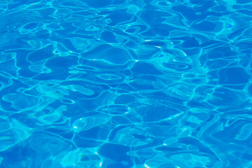 Fototapeta na wymiar Swimming pool water surface with sparkling light reflections. Aqua background.